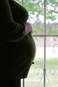 Pregnant Woman in front of window