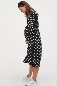 Midi length black dress with white polka dots