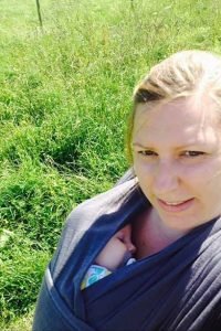 Sian wearing her baby snuggled in a blue close caboo carrier