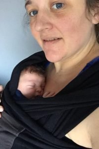 Kelly wearing a black Je Porte Mon Bebe wrap