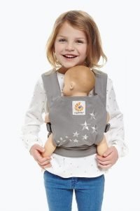 Child carrying her doll in an ergo