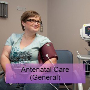 Woman sat having her blood pressure taken - antenatal care research and guidelines