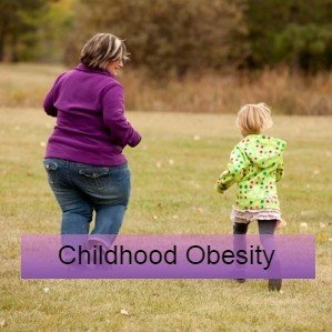 A mum and child play in a field - childhood obesity research and guidelines