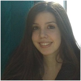 Headshot of Dr Moscho Michalopoulou. She has long, dark brown hair and a big smile